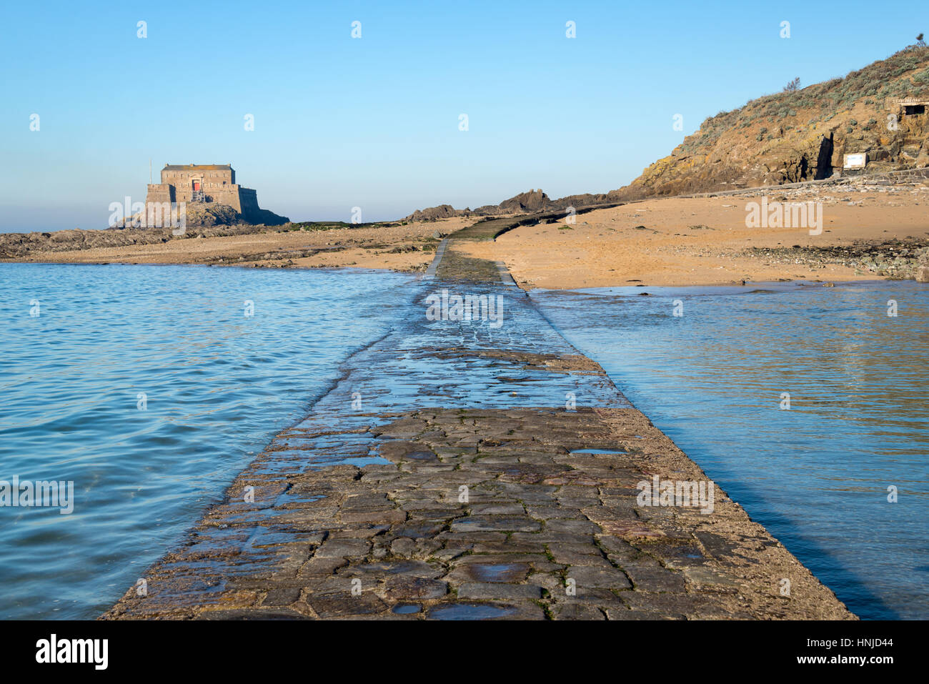 Paved path to Grand Be and Petit Be islands at low tide in Saint Malo, Brittany, France Stock Photo