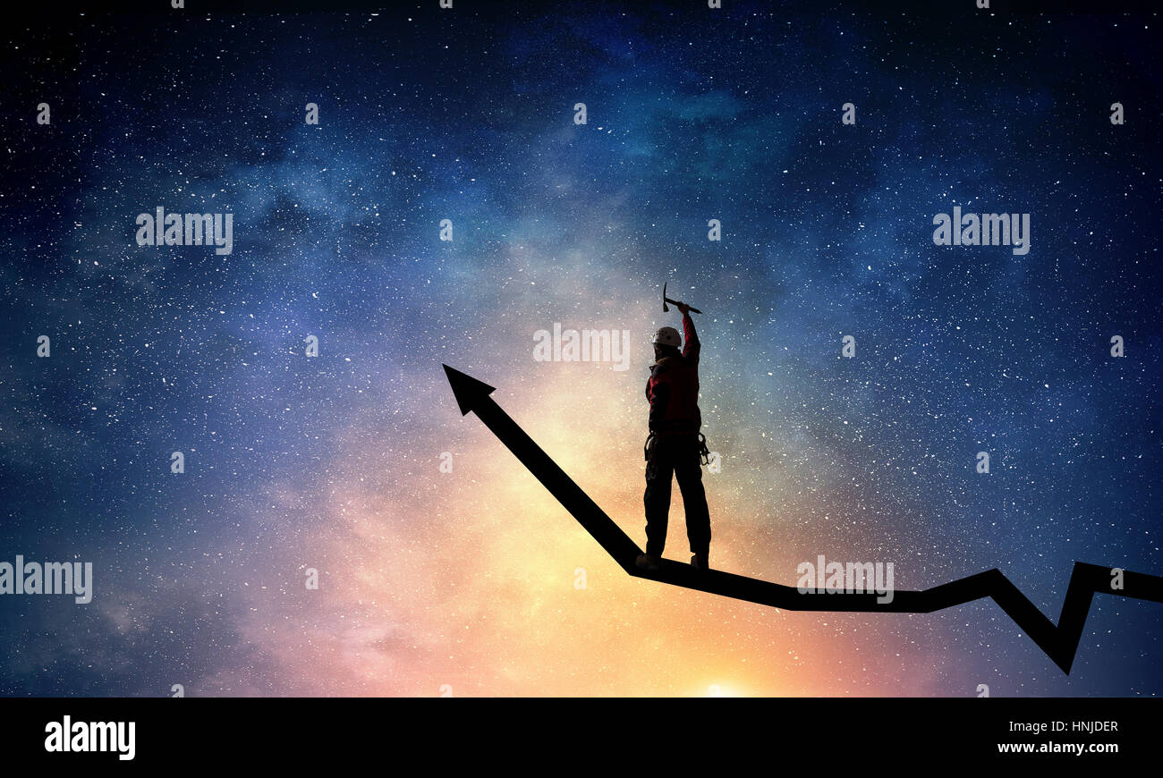 Young brave man alpinist climbing growing graph Stock Photo