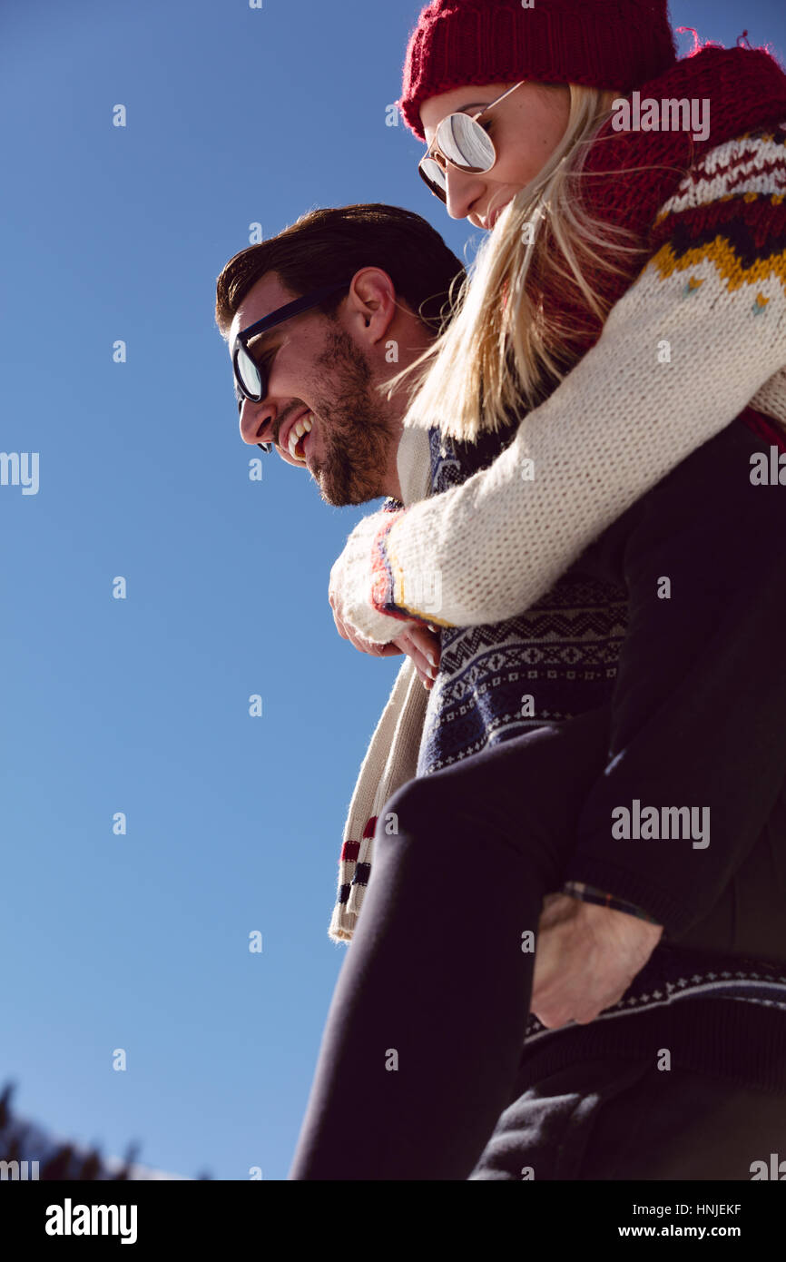 Young couple enjoying piggyback ride isolated on gray background Stock  Photo - Alamy