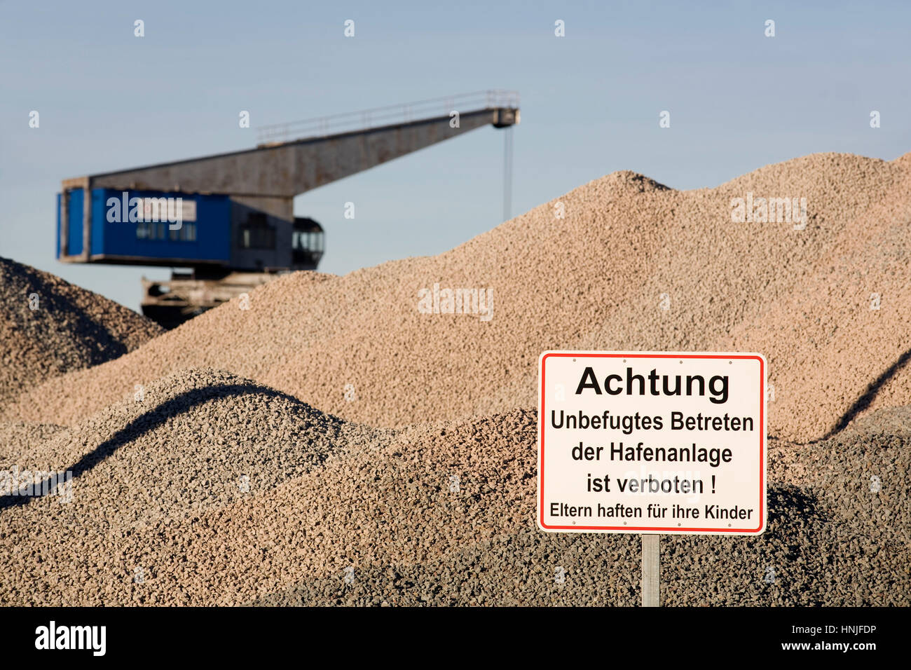 Europe, Germany, Ruhr Area, Dortmund, the harbor at the Dortmund-Ems-Canal, crane and heap with gravel. Stock Photo