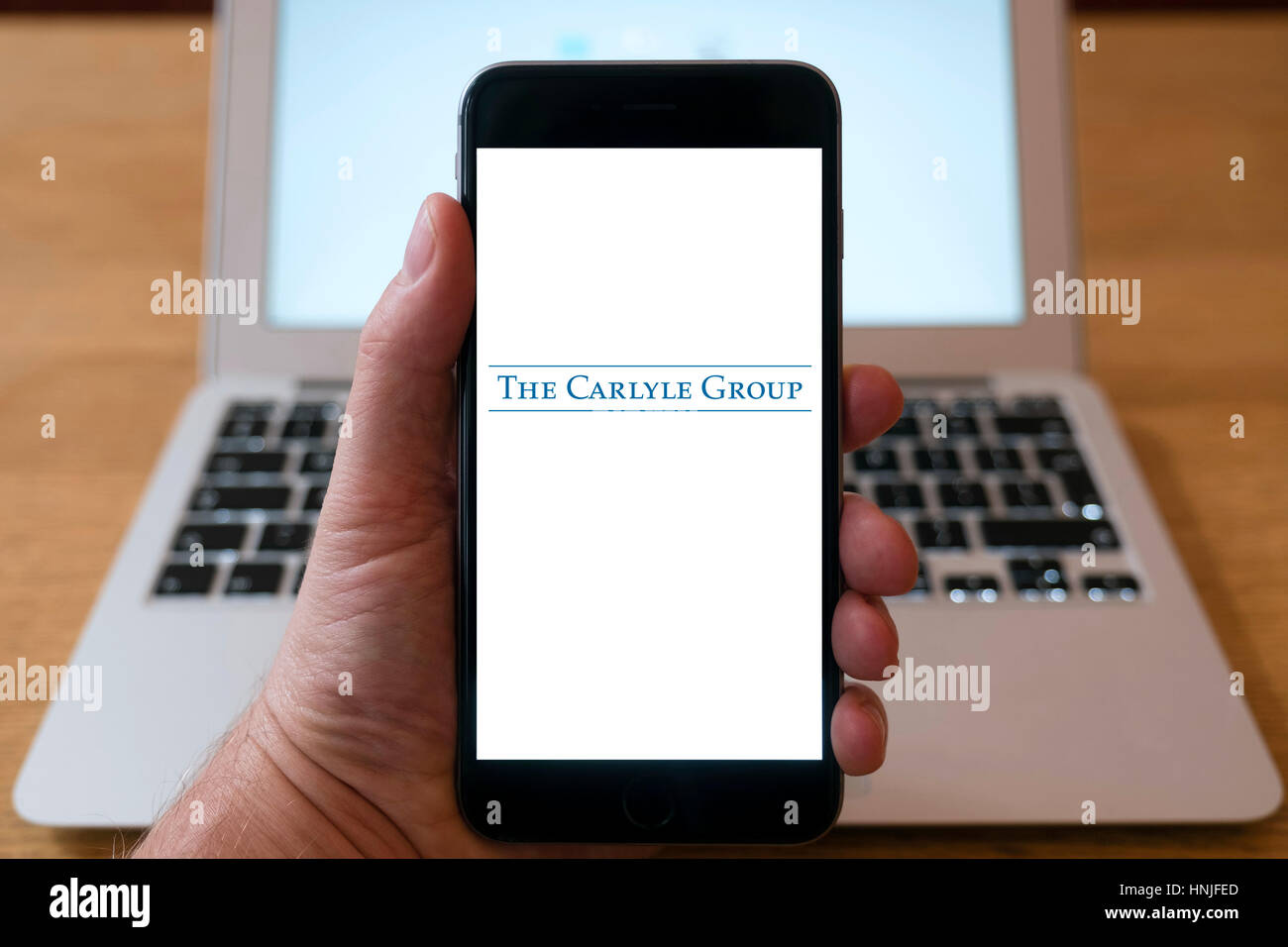 Logo of Carlyle Group private equity company on smart phone screen. Stock Photo