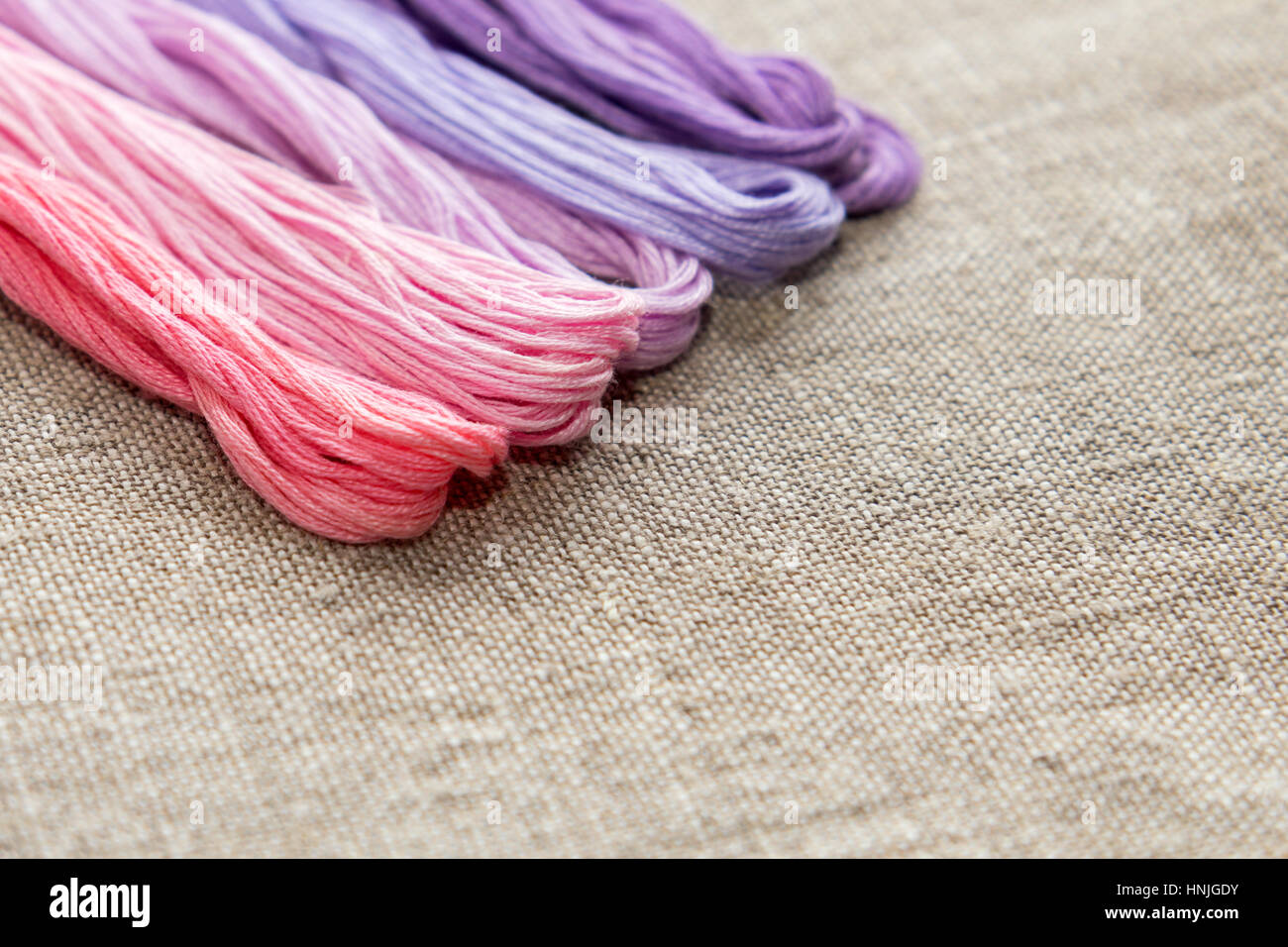 Set for embroidery. Embroidery thread shades of violet and pink color ...