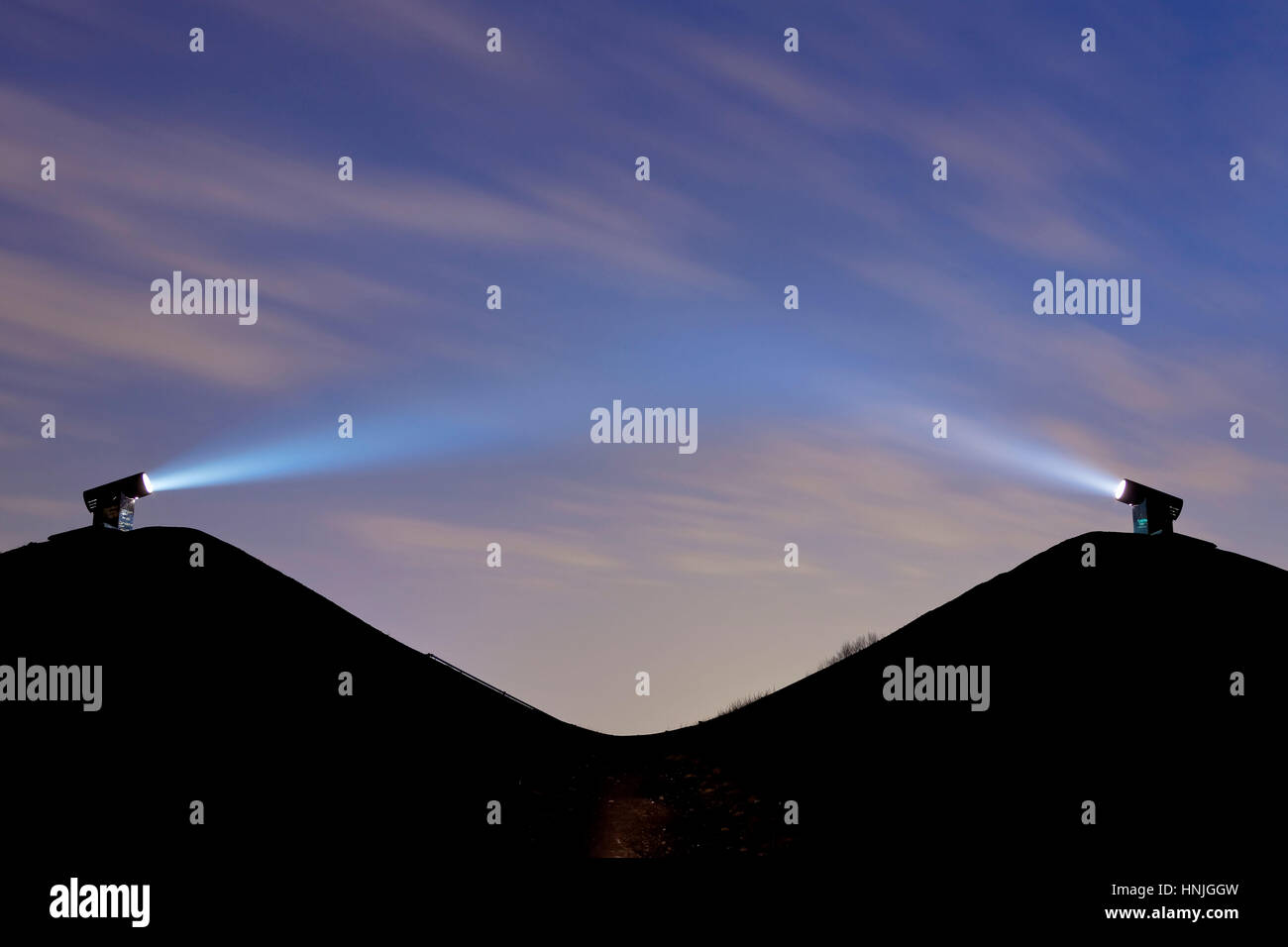 Germany, Ruhr area, Gelsenkirchen, the heap Rungenberg, two laser spots on the heap illuminates the sky by night, light installation Nachtzeichen. Stock Photo