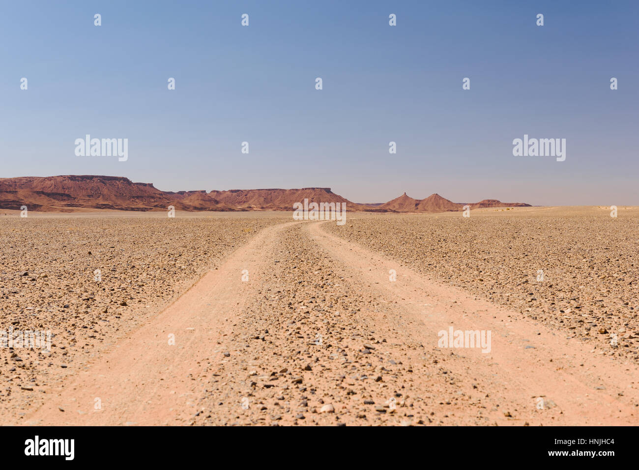 Dusty off-road track leading to the horizon, Morocco Stock Photo