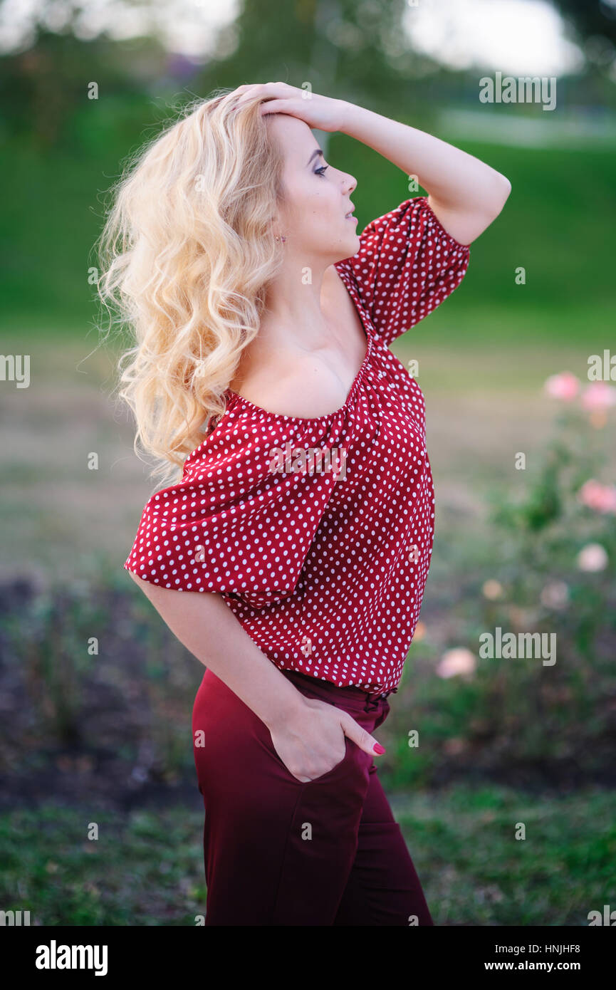 beautiful young woman walking in a summer park Stock Photo