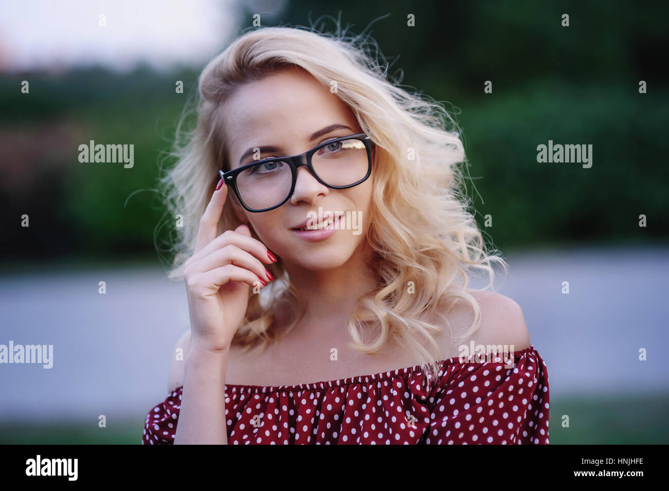 young woman in glasses on a background of lake Stock Photo