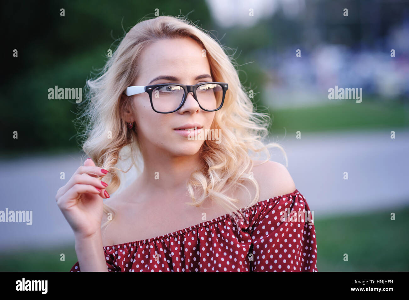 young woman in glasses on a background of lake Stock Photo