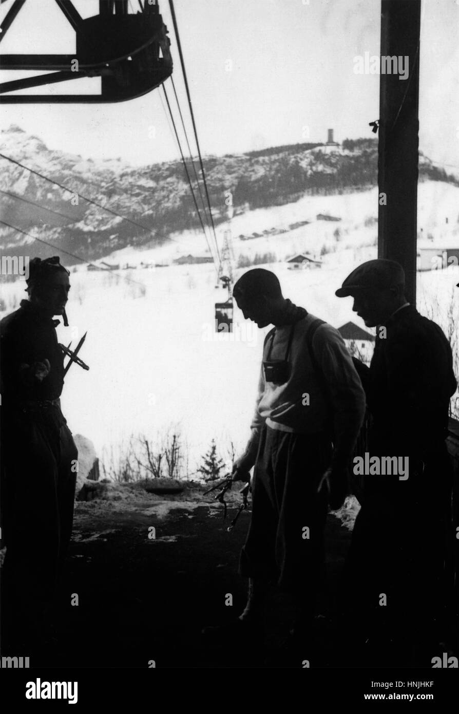 January 1939, Skiers wait for the teleferic in Pocol, Cortina, Italy.   Scan from analog photography, private family collection before WWII. Stock Photo