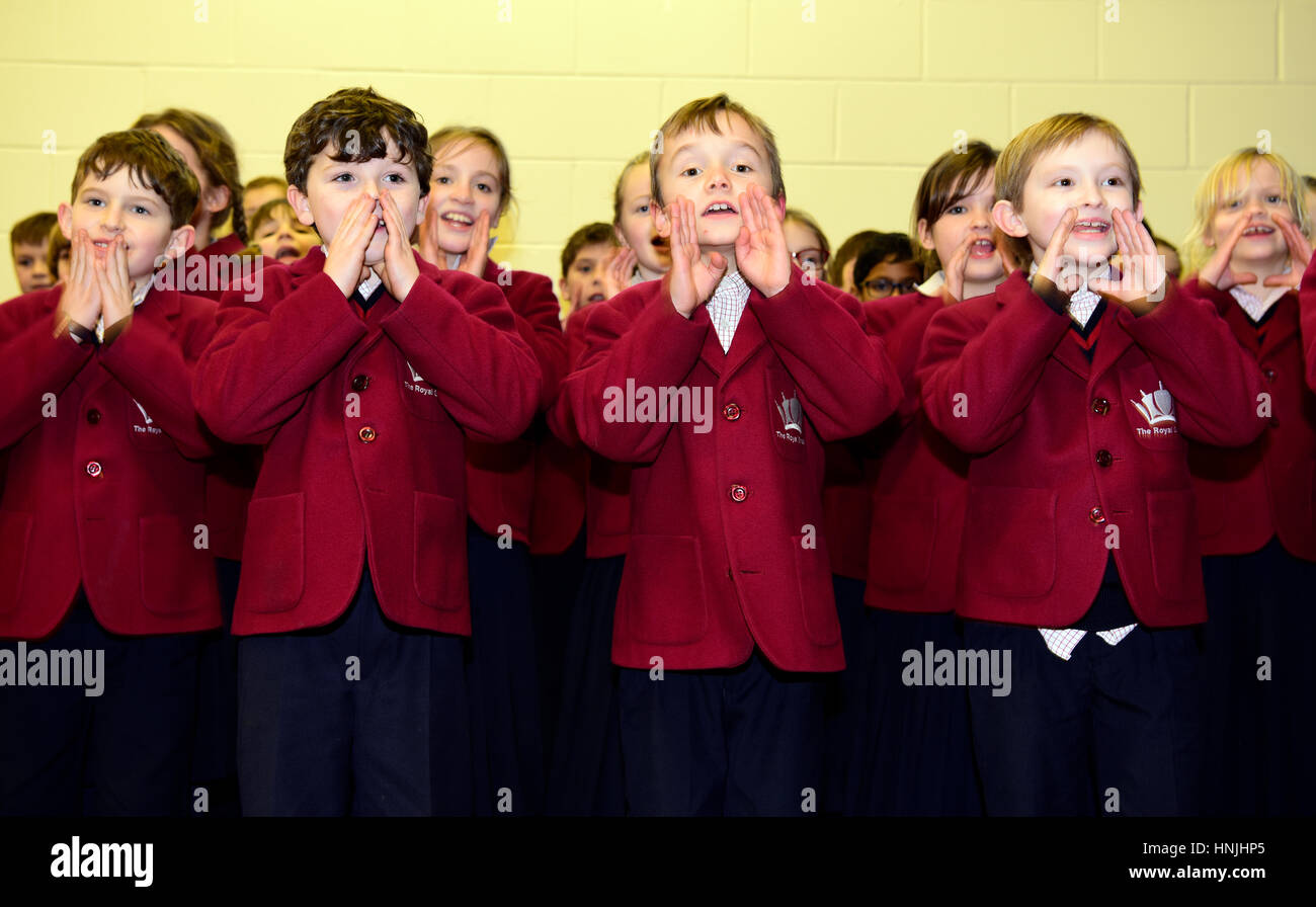 Junior school pupils performing a singalong for their grandparents at a school open day, Hindhead, Surrey, UK. Stock Photo