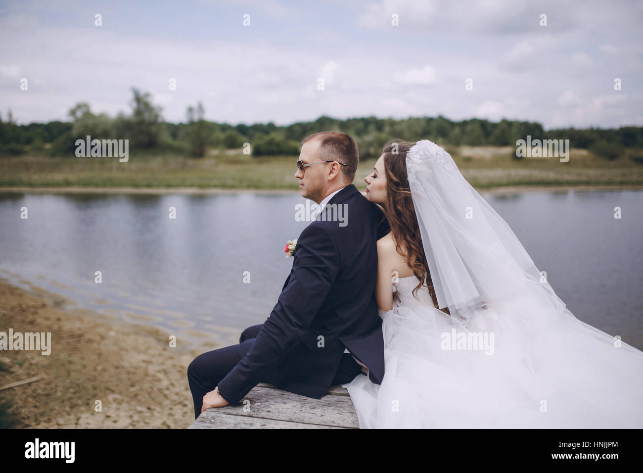 Bride and groom back view sitting hi-res stock photography and images ...