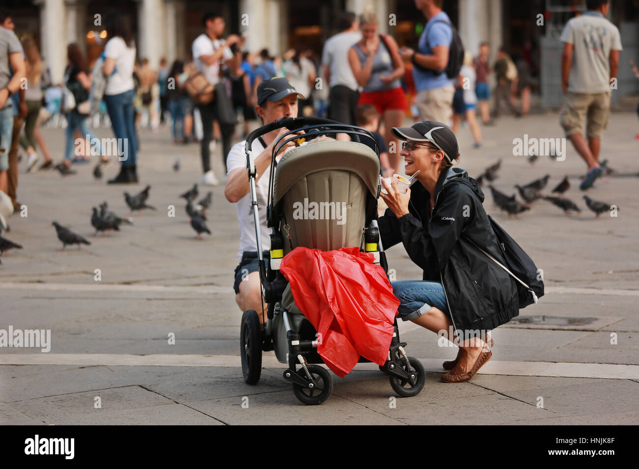 Tourists visit San Marco square in Venice.They take pictures and selfie and enjoy with the pigeons. Stock Photo