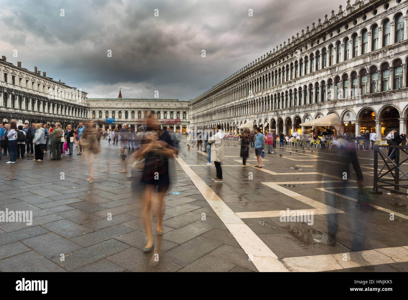 Tourists visit San Marco square in Venice.They take pictures and selfie and enjoy with the place.Venice attracts tourists from all over the world. Stock Photo