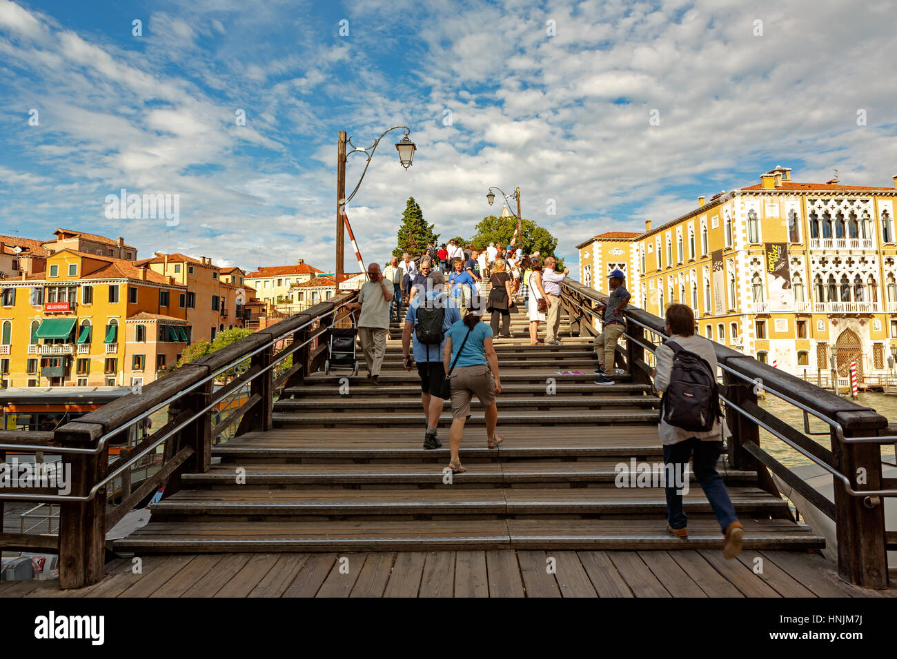 Venice, Italy - September 19, 2016 :People passing the 'Ponte dell'accademia' bridge. It is one of the biggest and  wooden made bridge in the city. Stock Photo