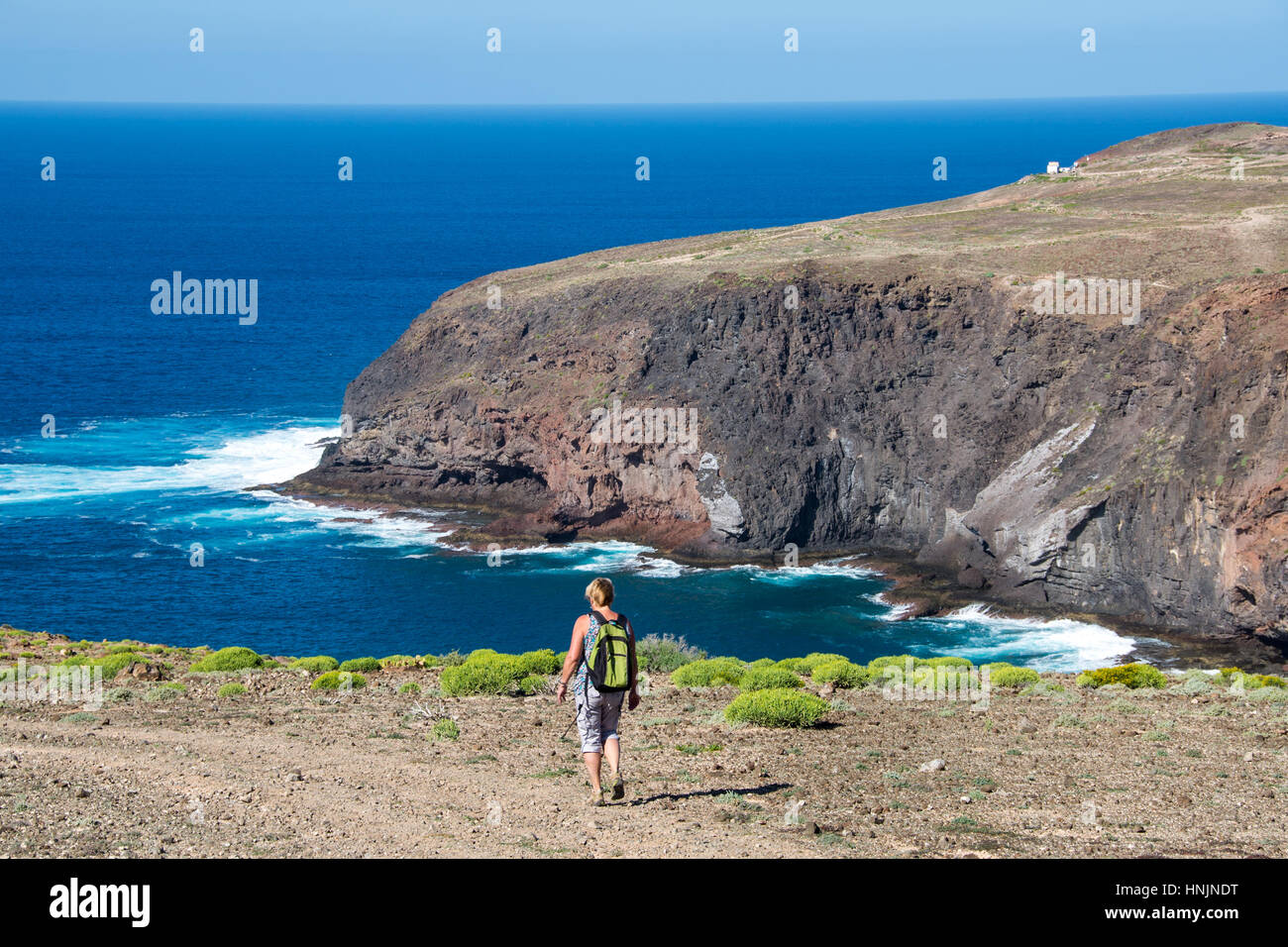 tourist walking at path at coastal path at el juncal, gran canaria, spain Stock Photo