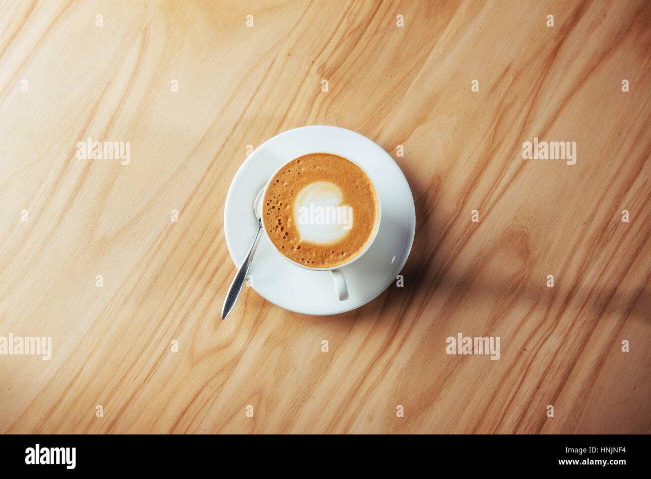 Art Cappuccino Coffee on Wooden table background Stock Photo - Alamy