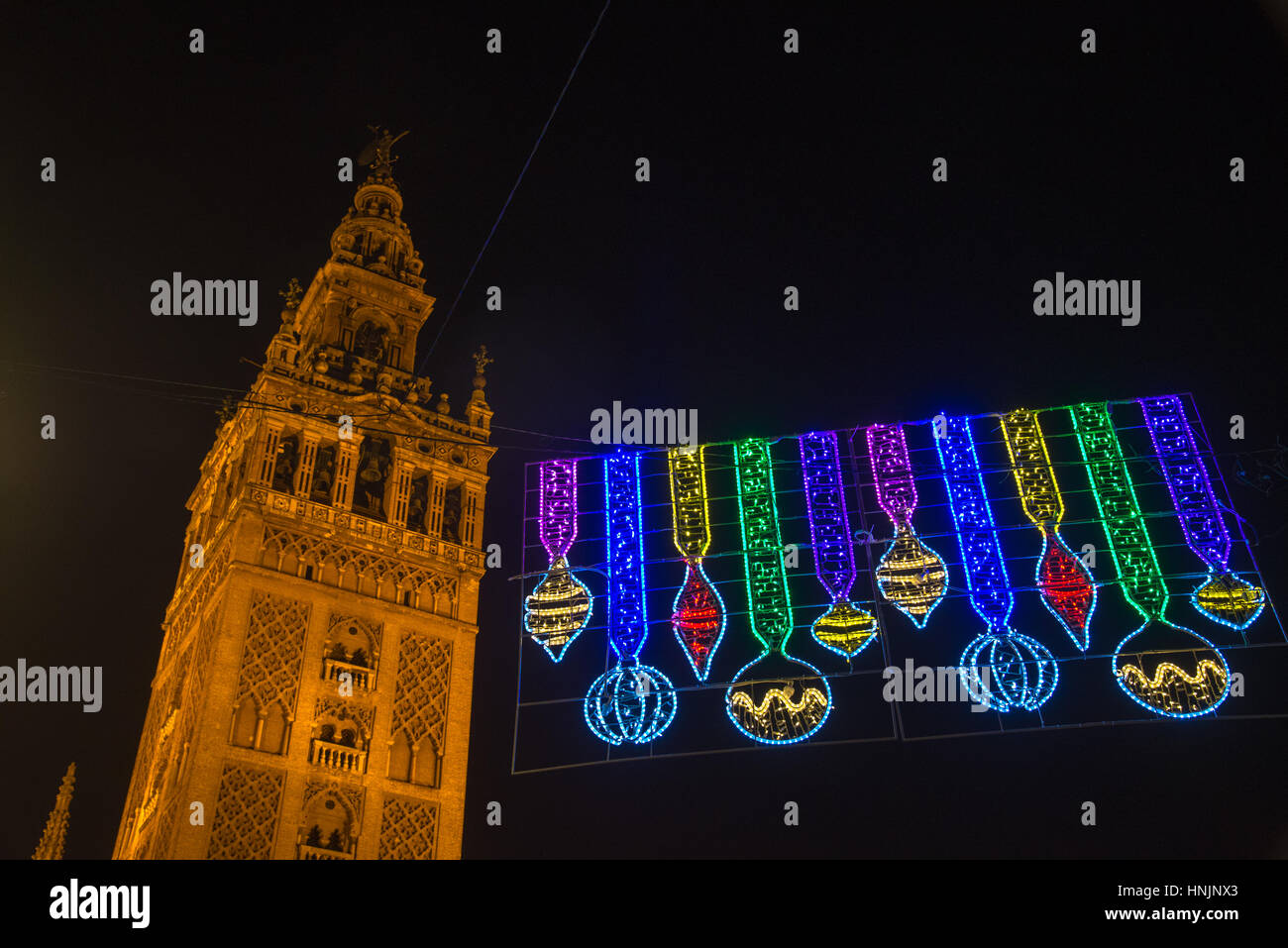 clocktower of giralda cathedral at night in sevilla spain with christmas lights Stock Photo