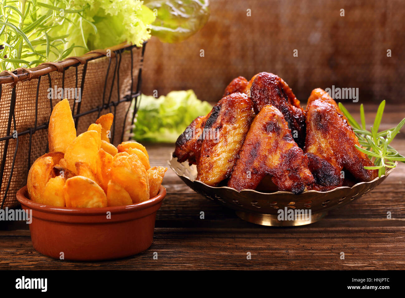 Chicken hot wings with baked potatoes Stock Photo