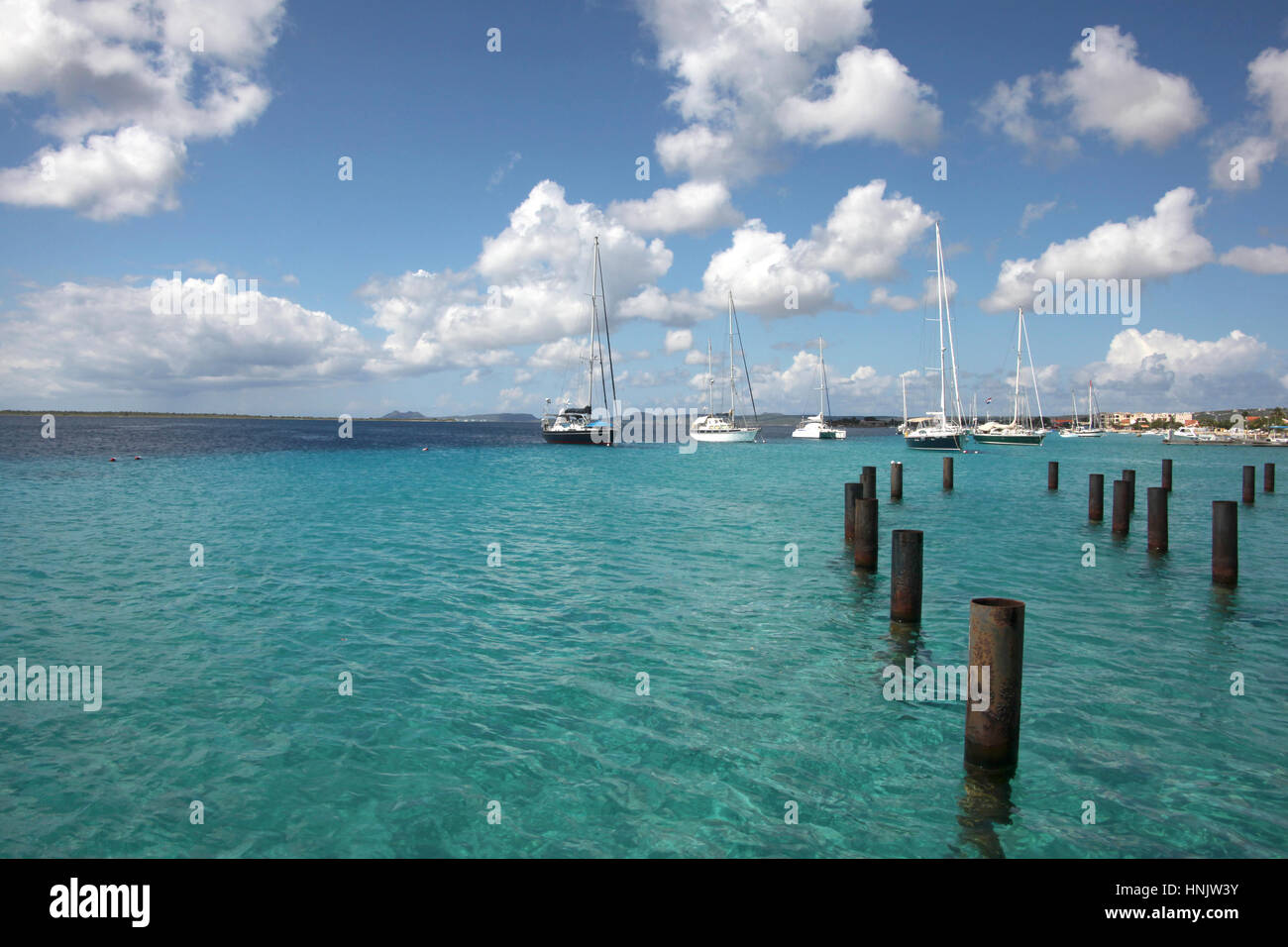Beautiful harbor of Kralendijk with turquoise water & blue sky. The city is in the background & little boats mored out to sea, Bonaire, Caribbean. Stock Photo