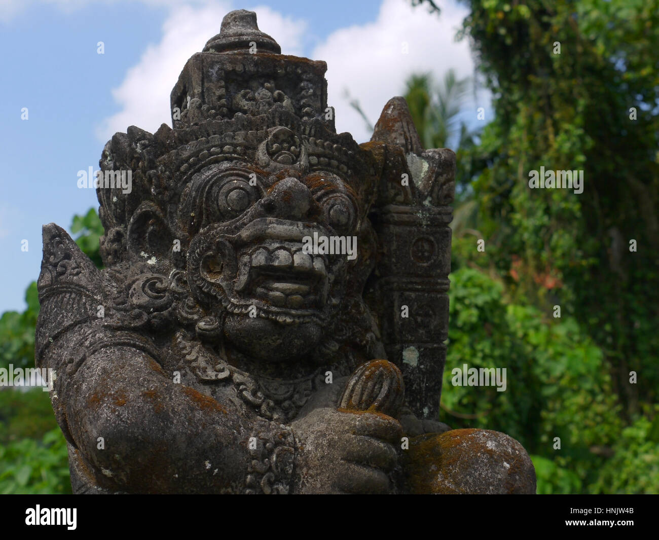 Bridge keeper spirit stone statue in rural Bali, Indonesia Stock Photo
