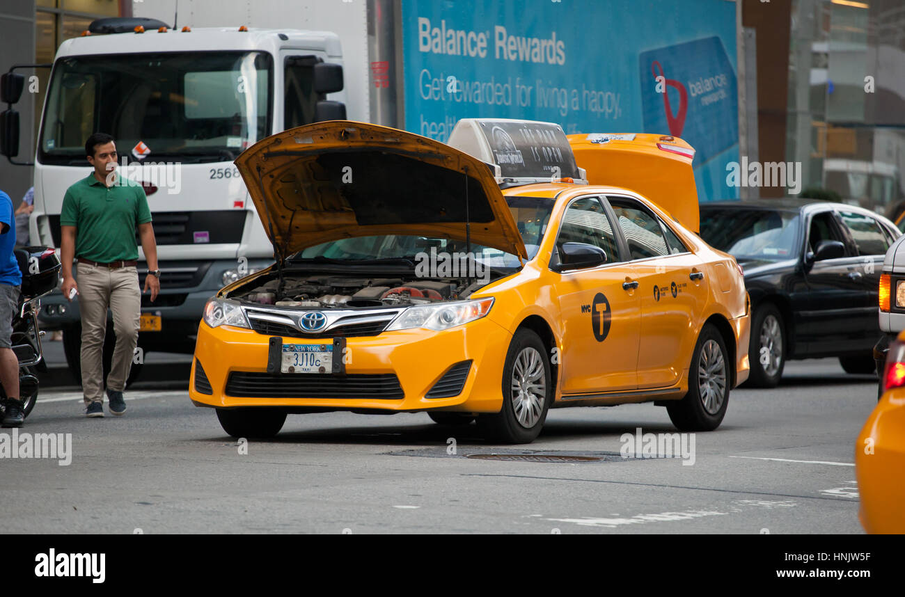 Yellow cab with broken engine in the center of Manhattan, NYC, USA. Stock Photo