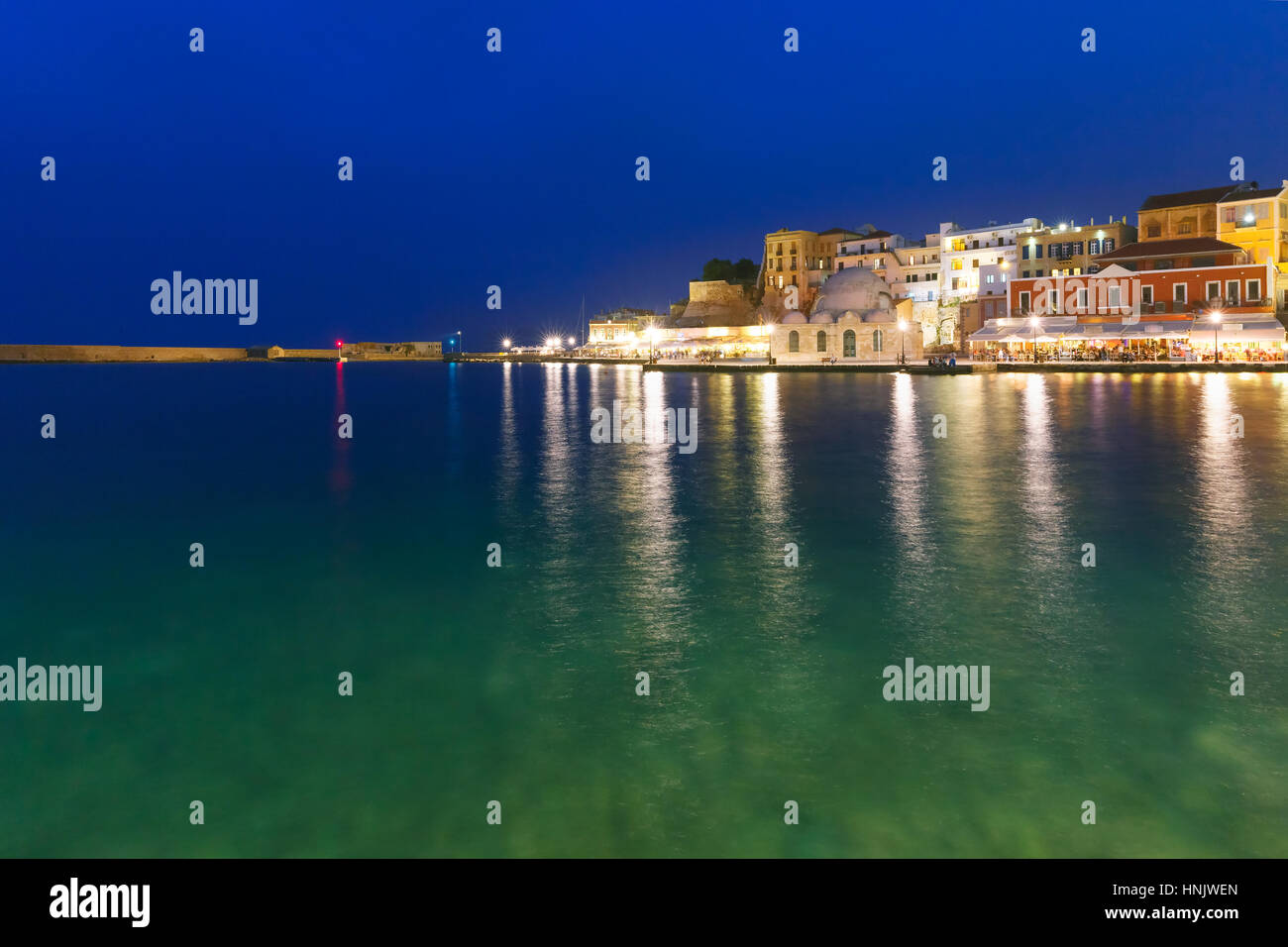 Picturesque view of Venetian quay of Chania with Kucuk Hasan Pasha Mosque during twilight blue hour, Crete, Greece Stock Photo