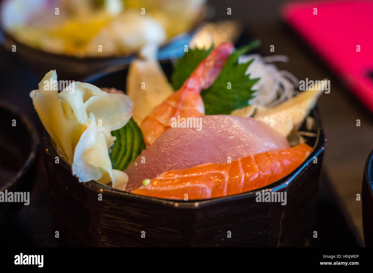 Closeup of Japanese chirashi sashimi rice bowl featuring ebi (shrimp