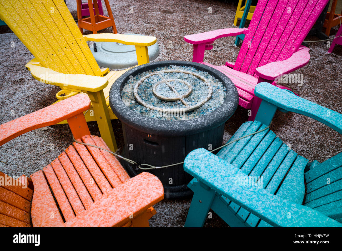 Colorful outdoor chairs in snow on patio of Boathouse Cantina restaurant; Salida; Colorado: USA Stock Photo