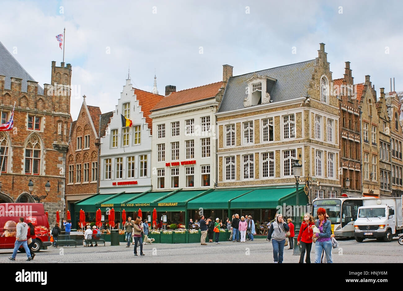 BRUGES, BELGIUM - MAY 26, 2011: The Markt Square is the best place to visit cafe or restaurant in historic stepped gable mansion and enjoy the view on Stock Photo