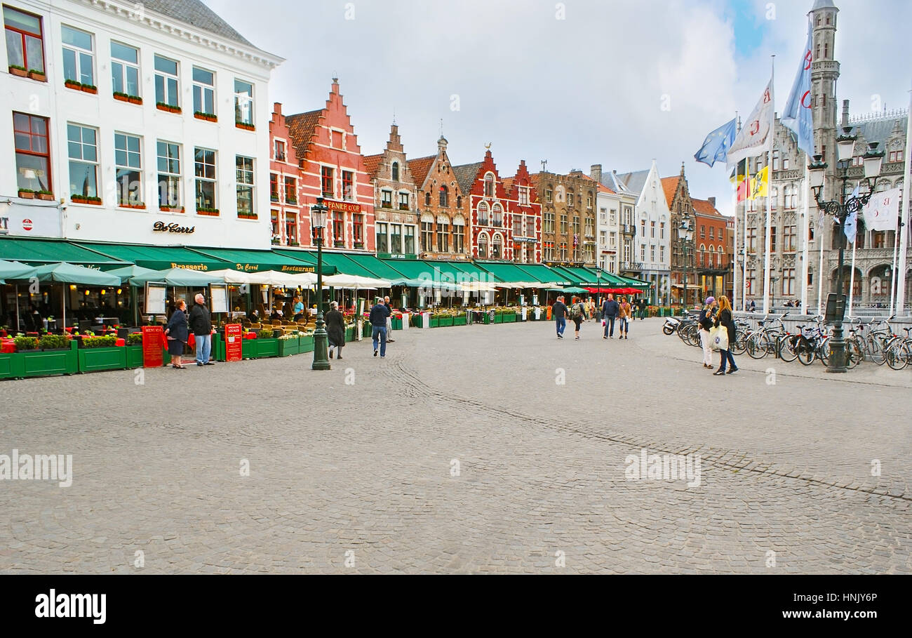 BRUGES, BELGIUM - MAY 26, 2011: The gourmet's paradise at the Markt Square, various cafes and restaurants occupy the ground floors of the old Dutch Re Stock Photo