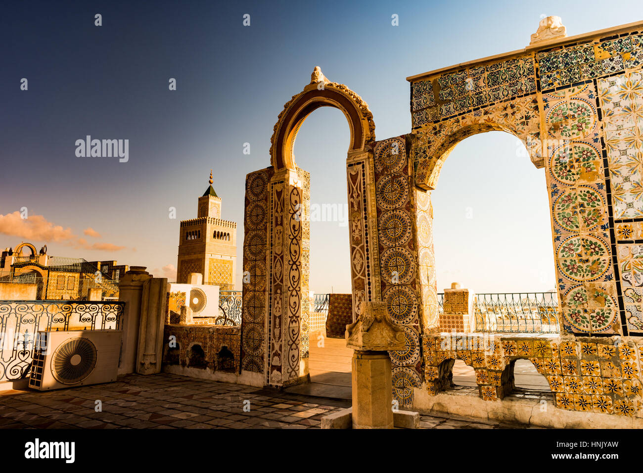 Detail of traditional arabic architecture in cityscape at dawn with dramatic sunlight. Tunisia, North africa. Stock Photo