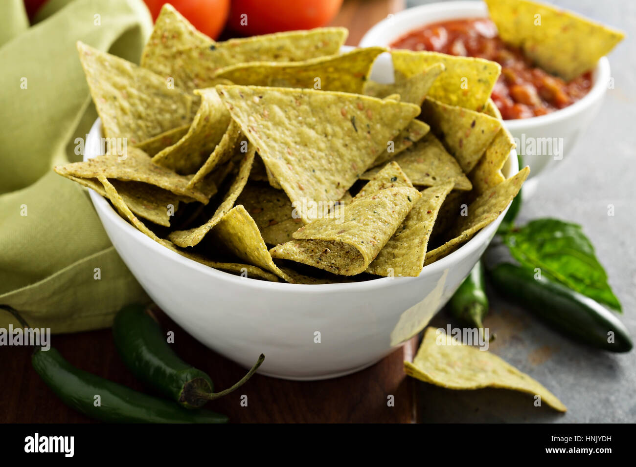 Healthy green corn tortilla chips with spinach and flax seeds Stock