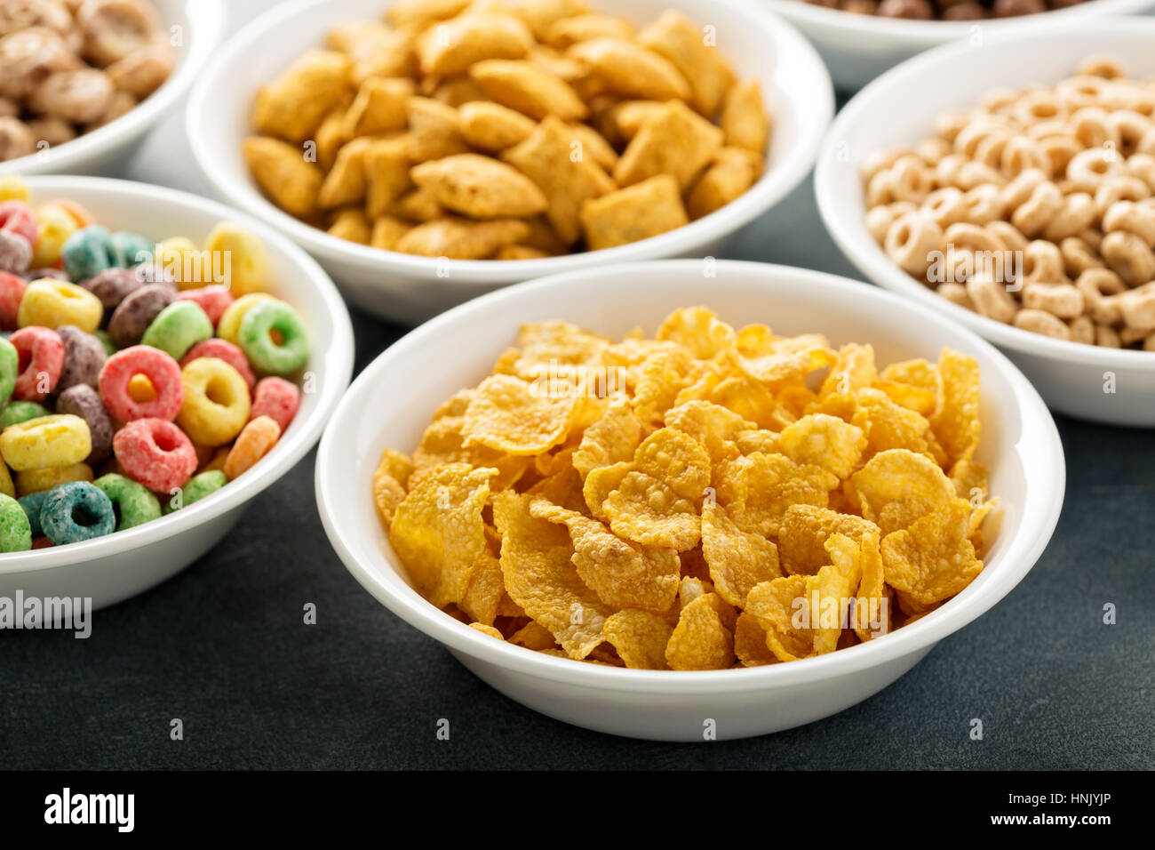 Variety of cold cereals in white bowls, quick breakfast for kids Stock