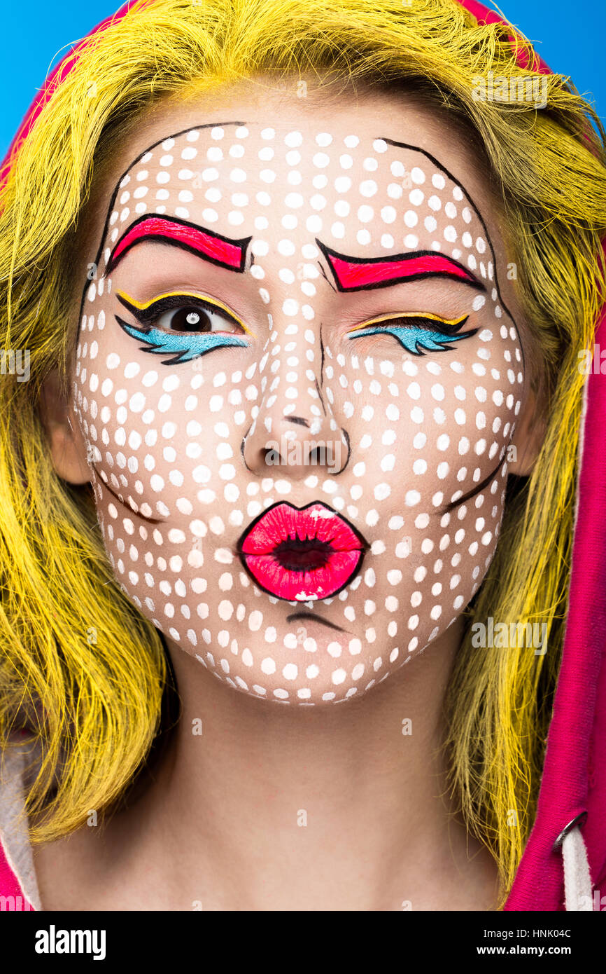 Photo of surprised young woman with professional comic pop art make-up and design manicure. Creative beauty style. Stock Photo