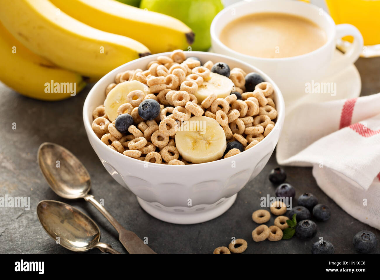 Healthy cold cereal with banana and blueberry in a white bowl, quick
