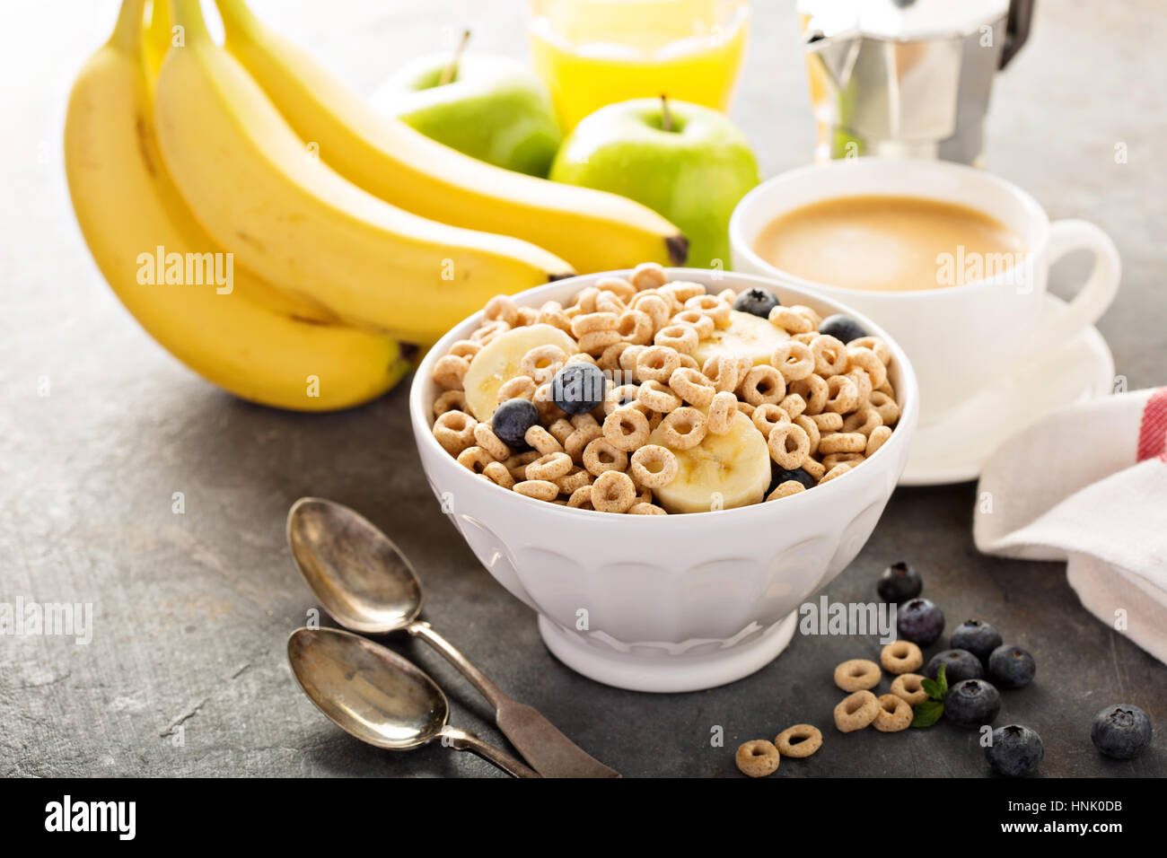 Healthy cold cereal with banana and blueberry in a white bowl, quick