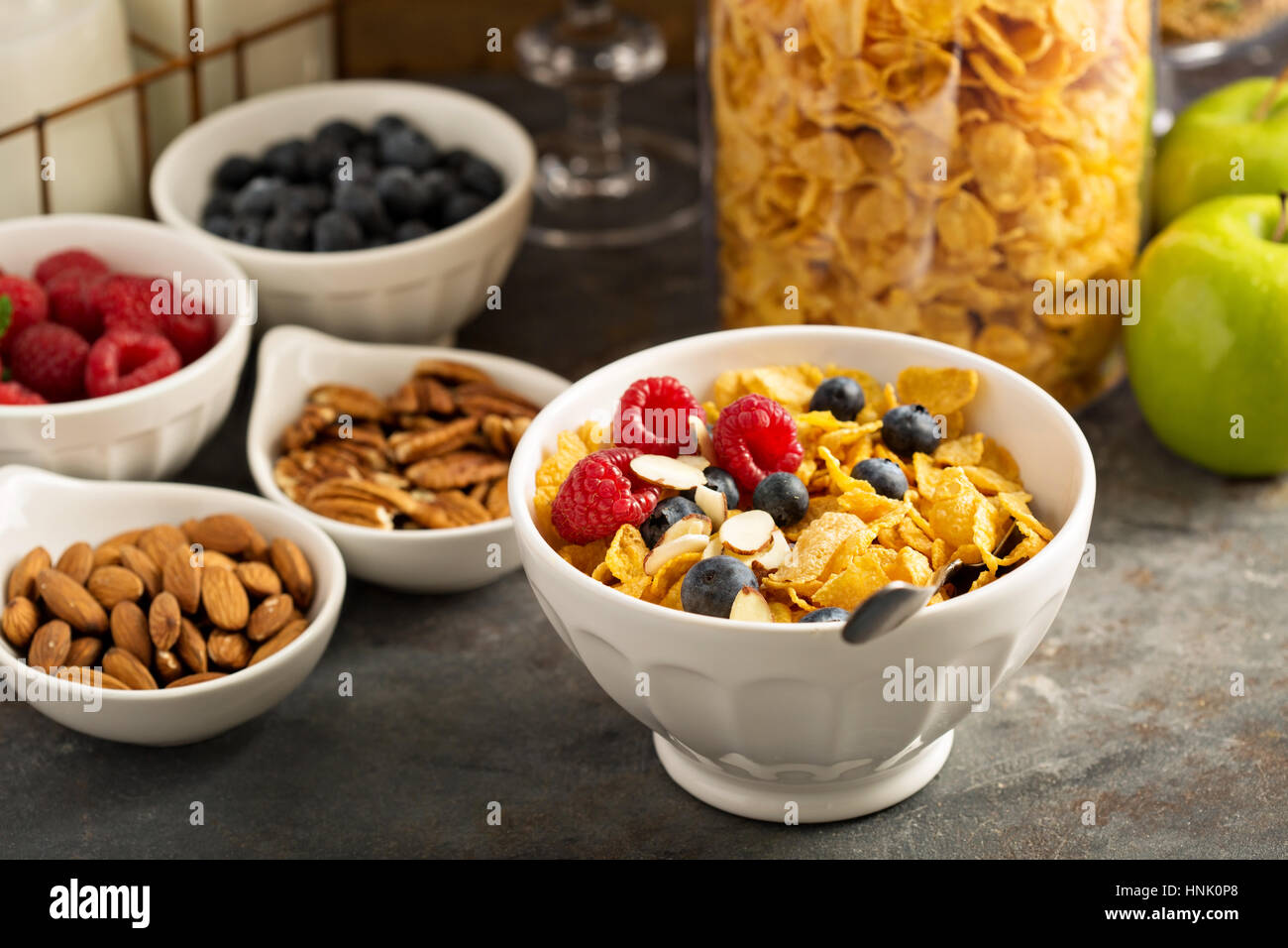 Breakfast cereal bar or buffet wih variety of cereals, fruit and nuts