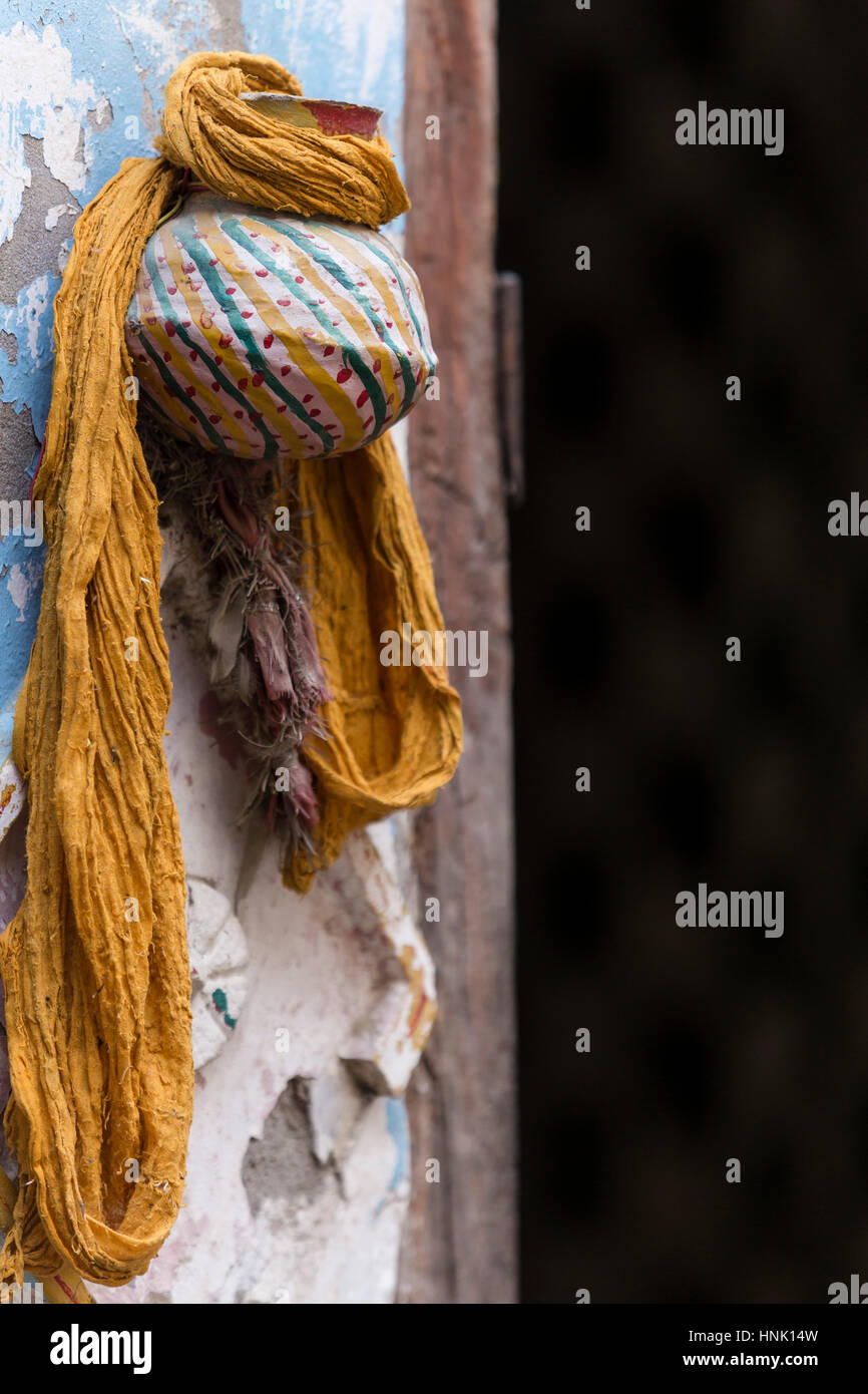 Yellow scarf hanging from a colorful vase. Ayodhya, Uttar Pradesh, India Stock Photo