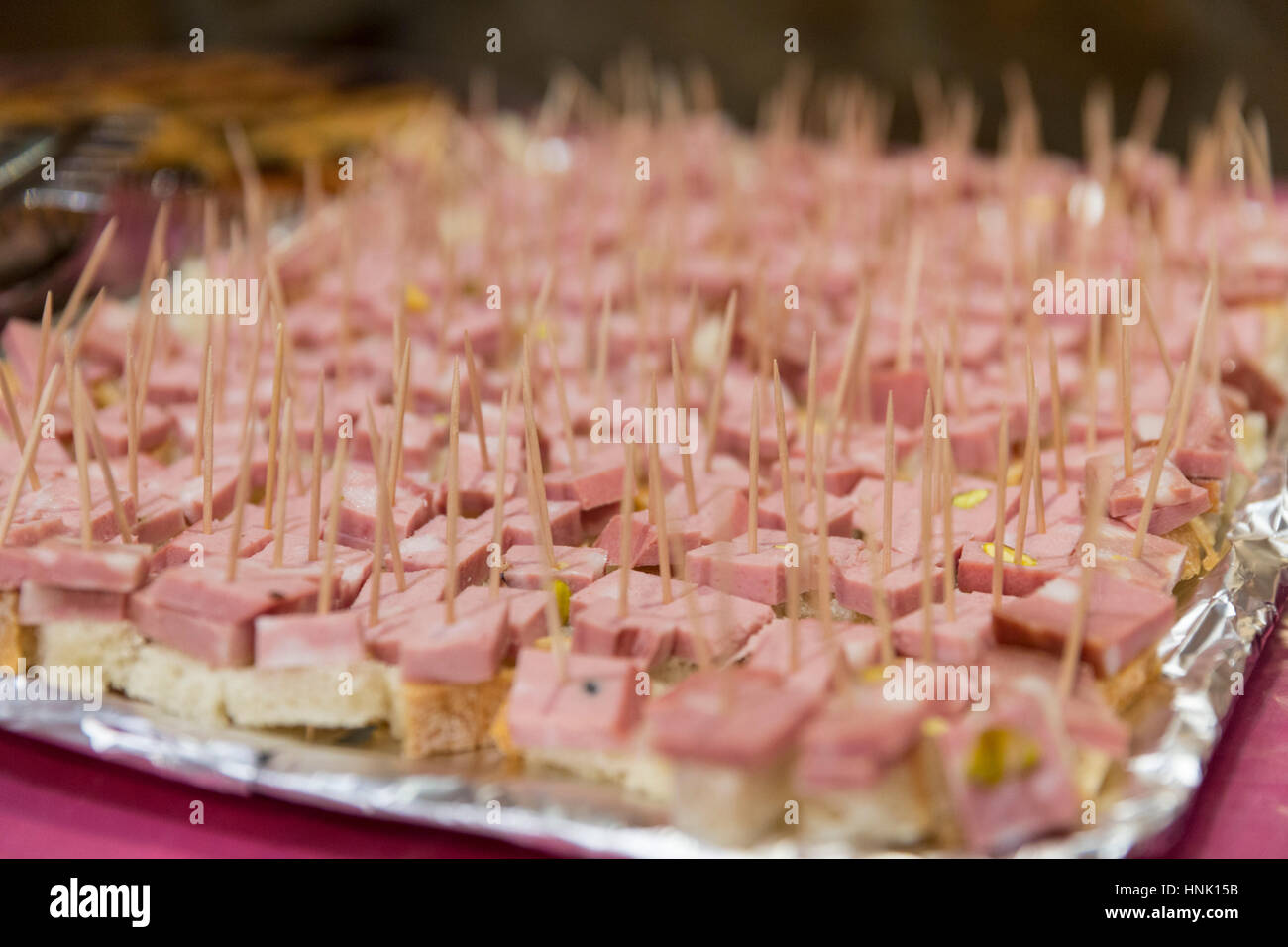 Mortadella cubes on bread Stock Photo