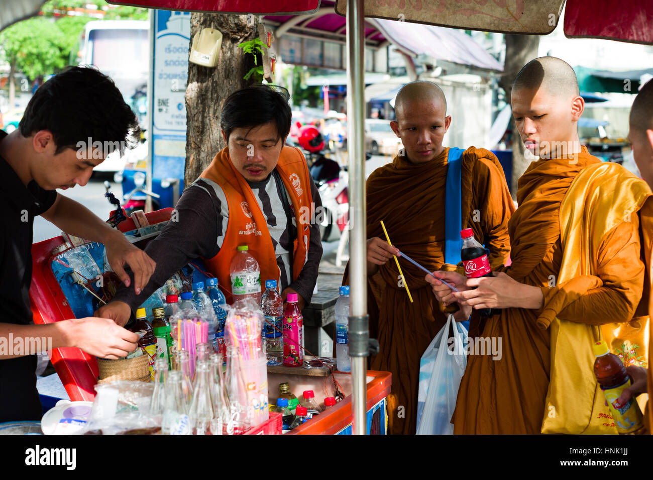 Young Buddhist monks buying coca cola Bangkok thailand Stock Photo