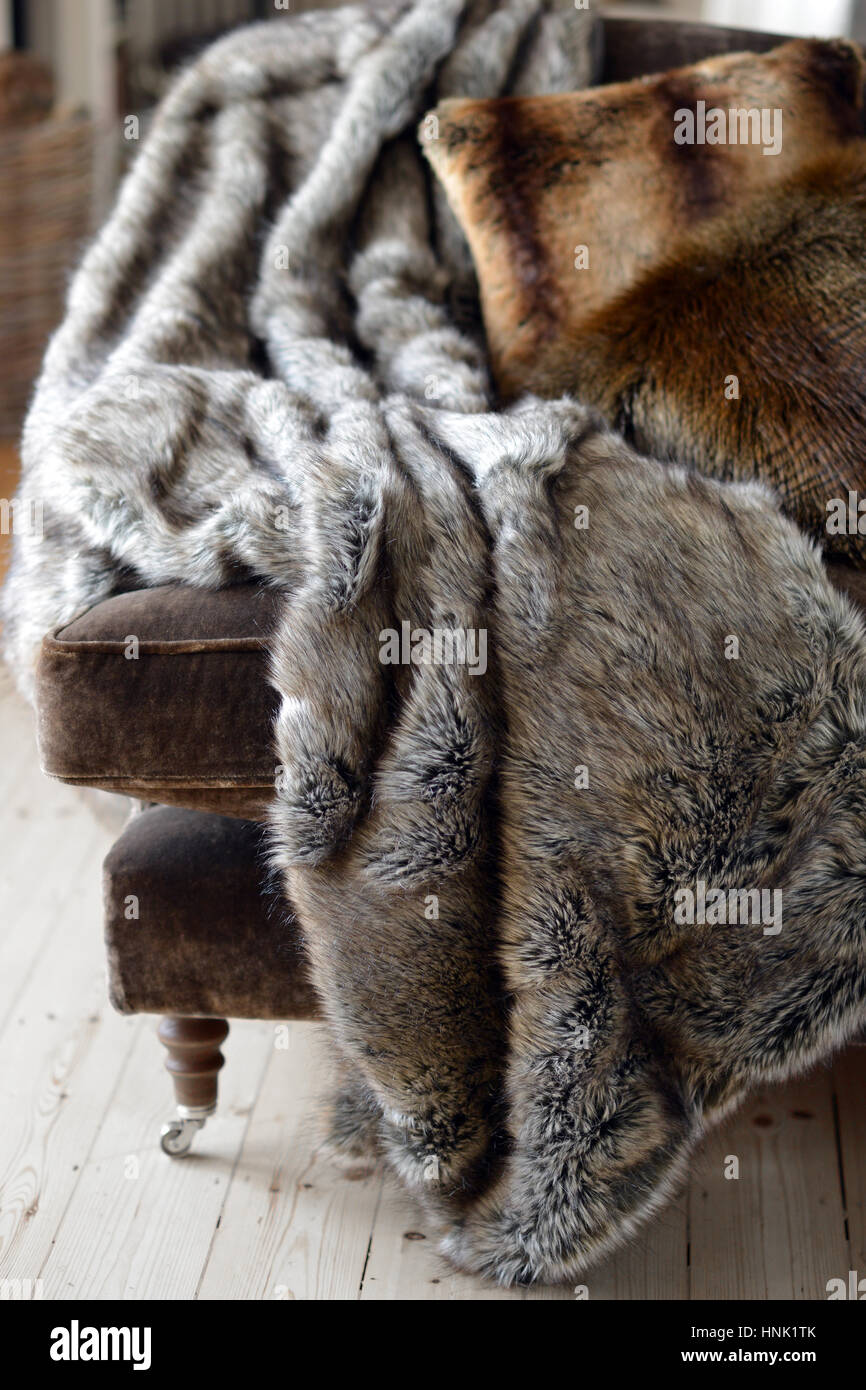 Faux fur throws and cushions room interior Stock Photo Alamy