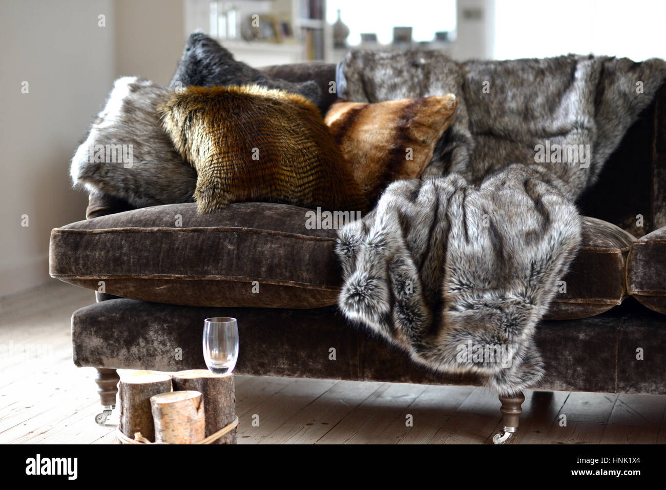 Faux fur throws and cushions room interior Stock Photo Alamy