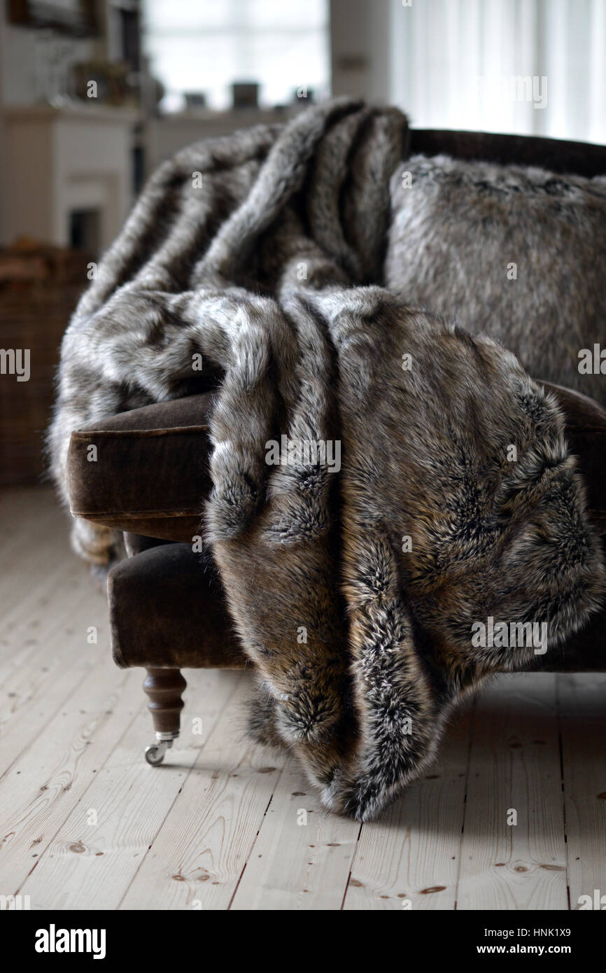 Faux fur throws and cushions room interior Stock Photo Alamy