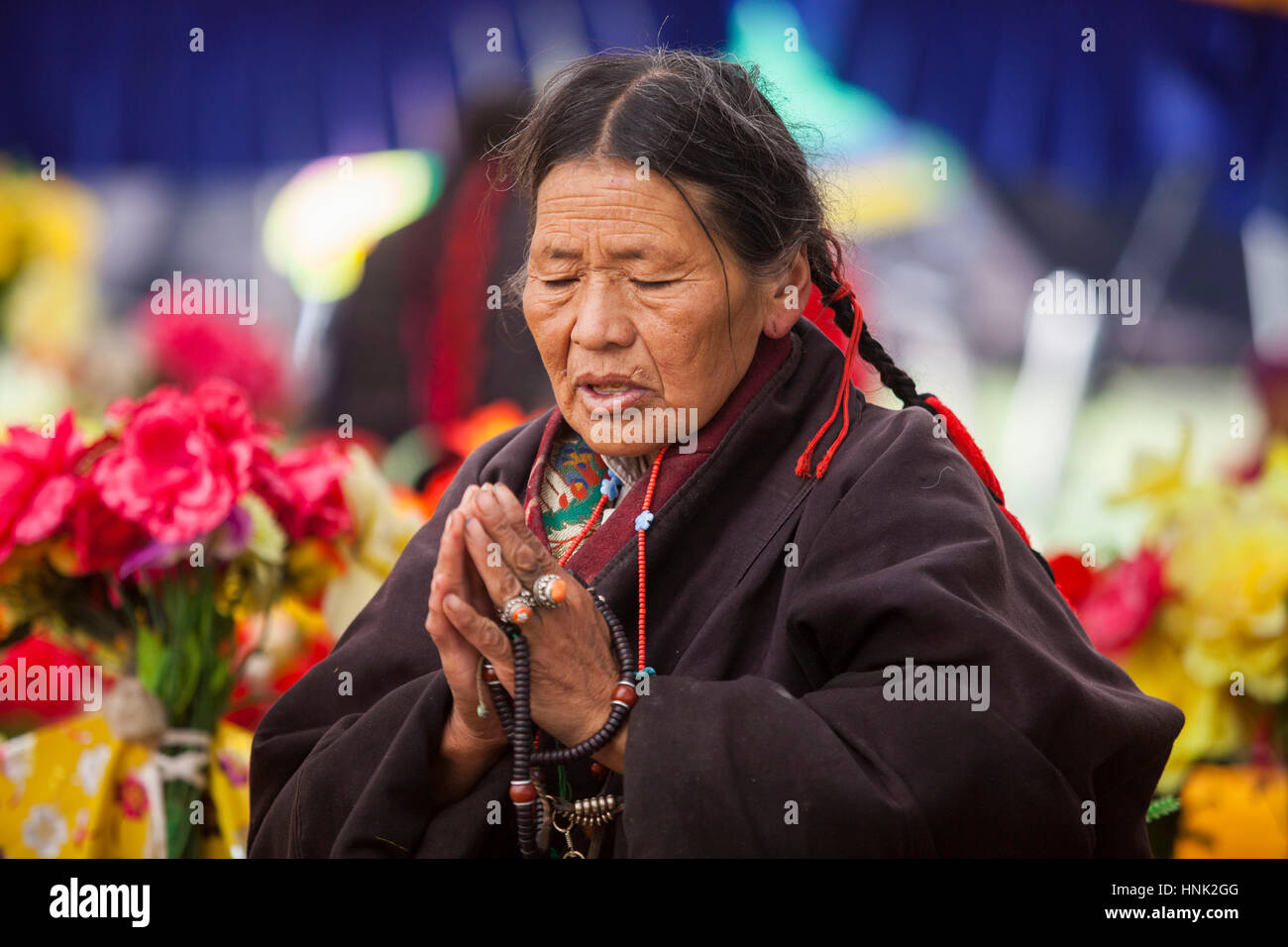 Khampa Tibetan men and women pray during a ceremony at the Tagong