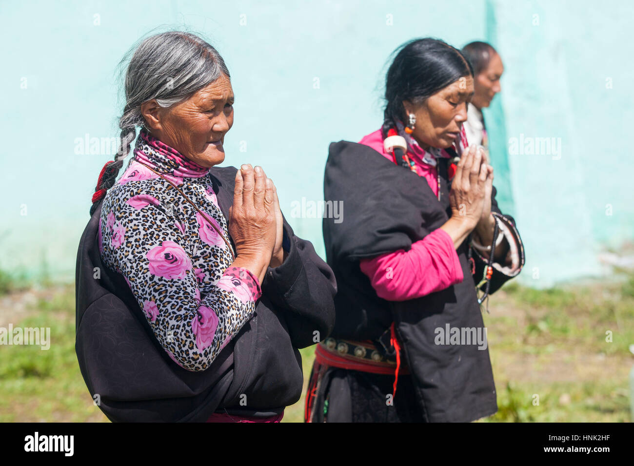 Khampa Tibetan men and women pray during a ceremony at the Tagong