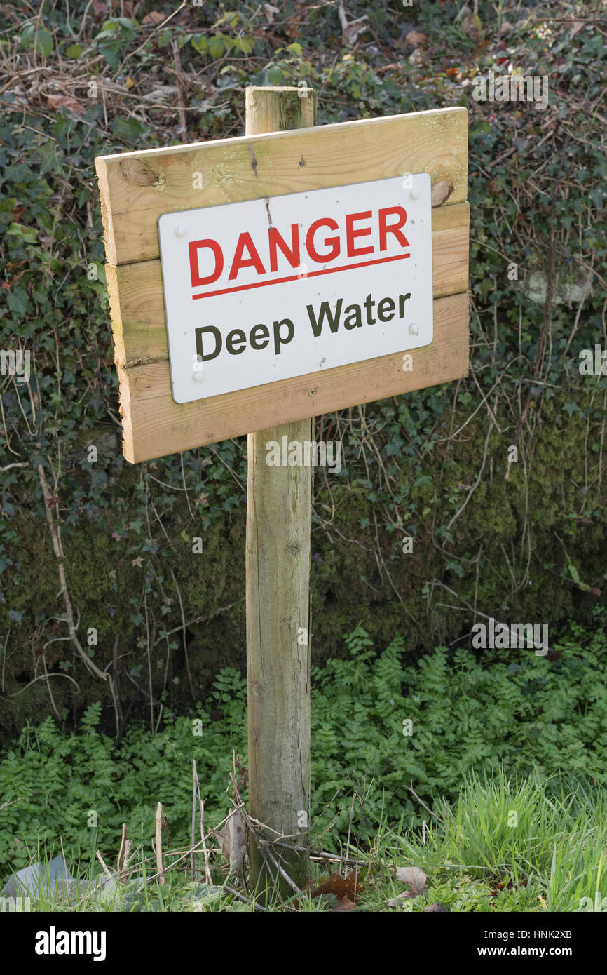 Danger 'Deep Water' sign beside a drainage ditch - in Cornwall, UK Stock Photo