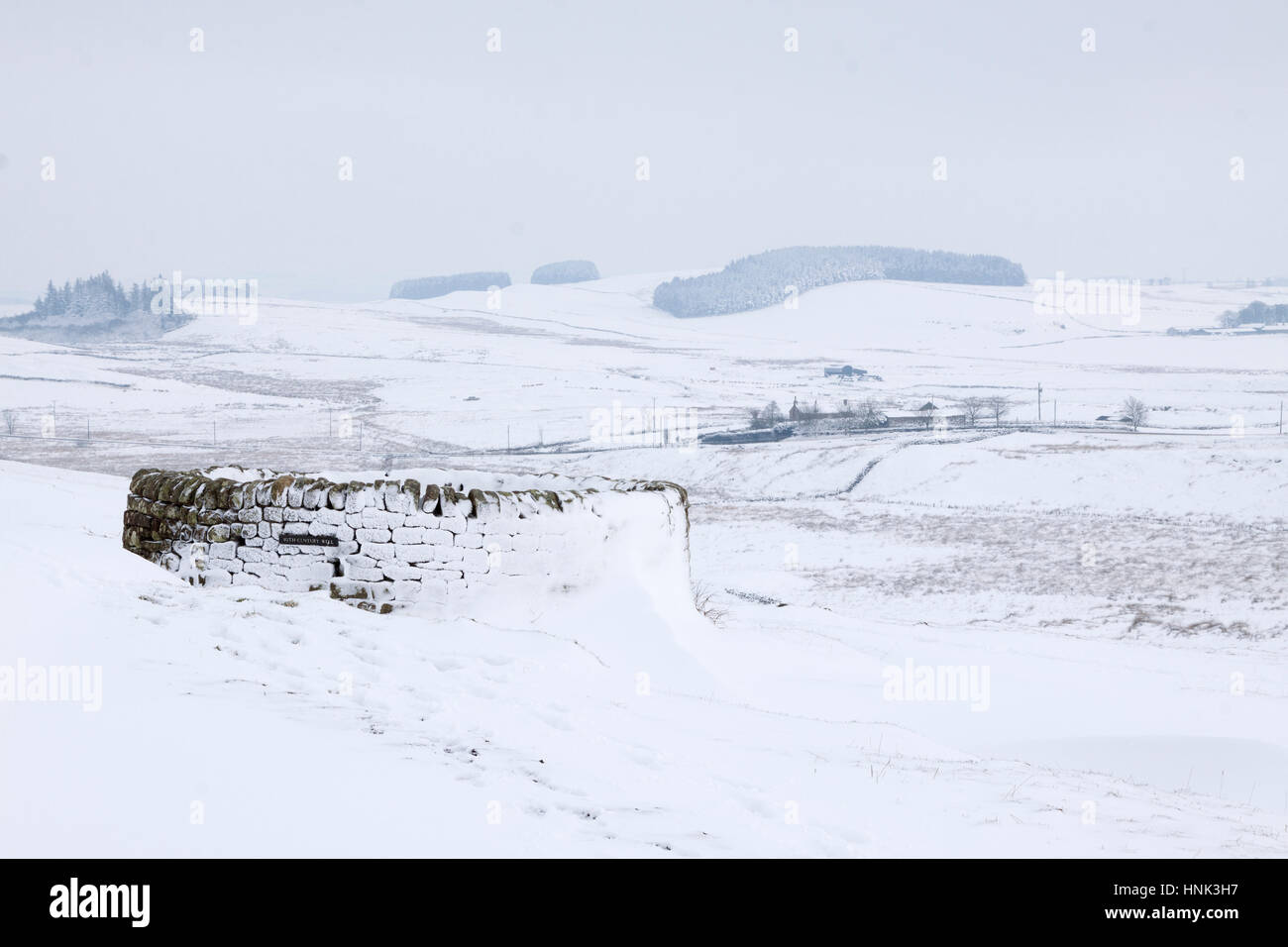 Hadrian's Wall: the current farmhouse at Housesteads replaced an earlier building that was close to the circular wall protecting the well, seen here Stock Photo