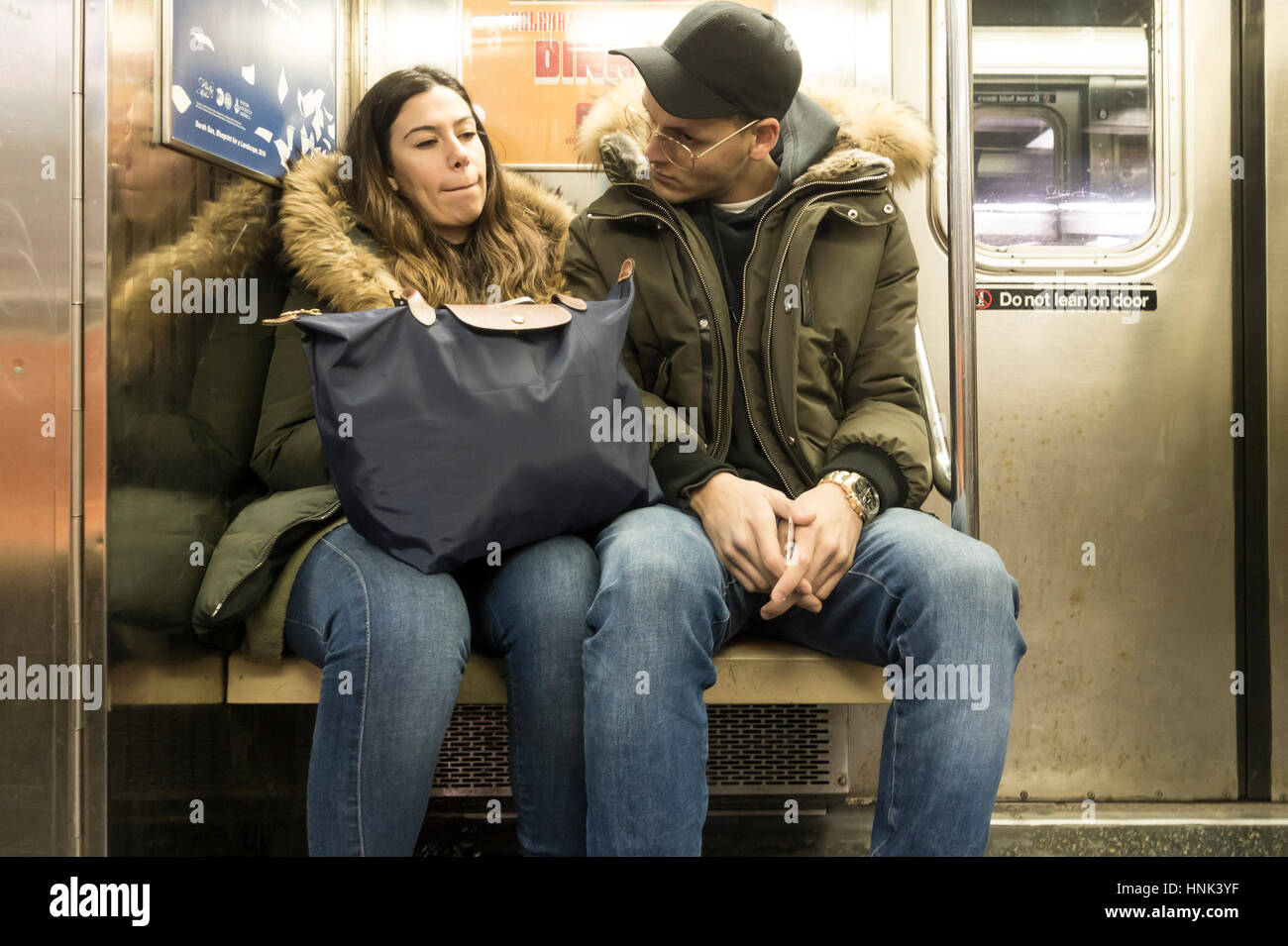 Young couple talking in a New York Subway train Stock Photo Alamy