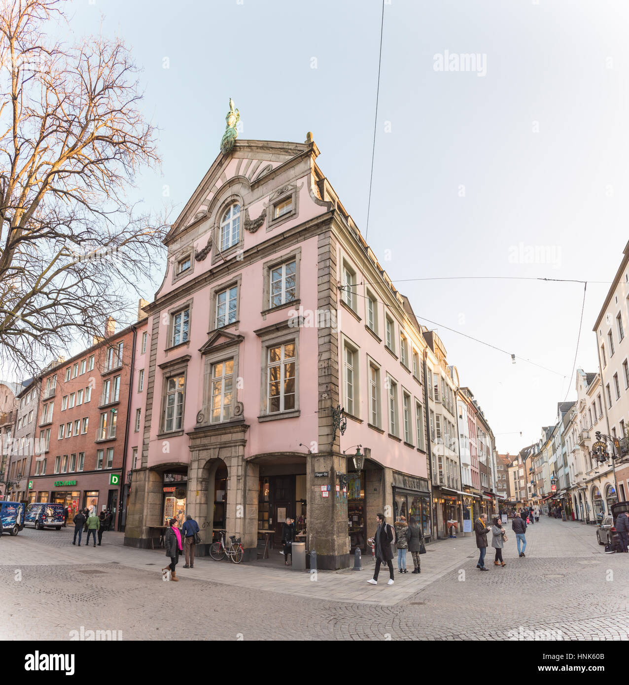 DUESSELDORF, GERMANY - FEBRUARY 13, 2017: Unidentified pedestrants walk through the Altstadt and pass an old pub Stock Photo