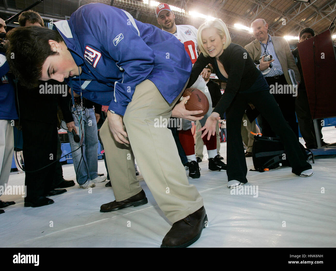 Giants center Shaun O'Hara (60) teaches former American Idol finalist Kellie Pickler how to receive a snap by Craig Falicon, left, during Media Day for Super Bowl XLII  at the University of Phoenix Stadium in Glendale, AZ, on Jan. 29, 2008.  Photo by Francis Specker Stock Photo