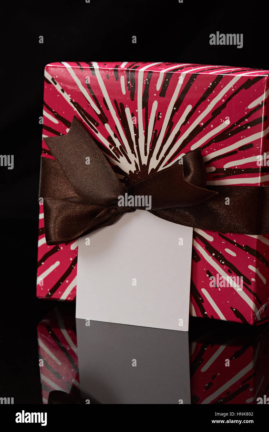 close up of colorful gift box isolated on black background Stock Photo